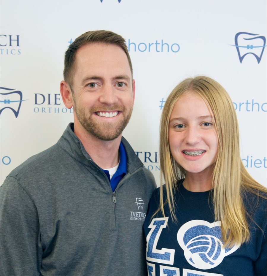 teen patient with braces smiling with Dr. Dietrich