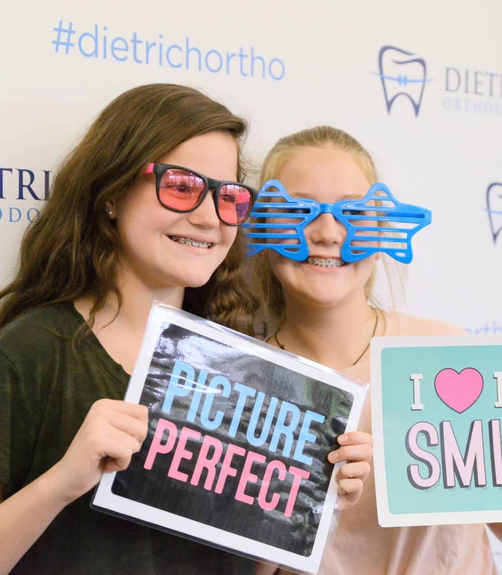dietrich orthodontics smiling patients with new smile signs